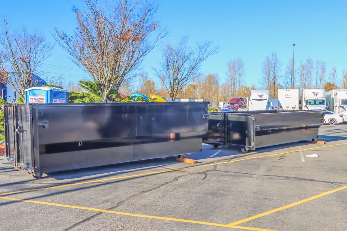 Professional dumpster rental service with roll-off container on residential driveway in East Nottingham